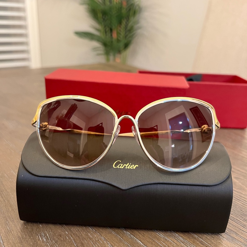Cartier's Trinity sunglasses in a two-tone silver and gold tones.
